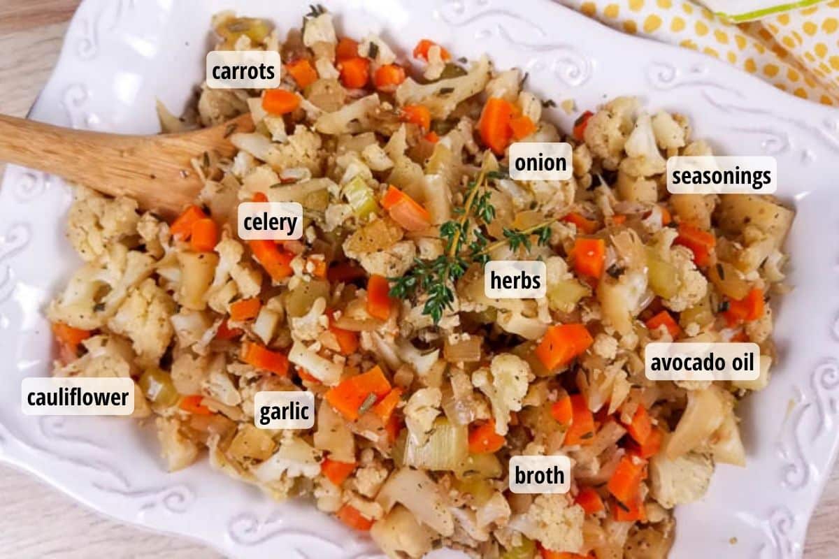 A white platter with cooked cauliflower stuffing and labels listing all of the ingredients in the recipe.