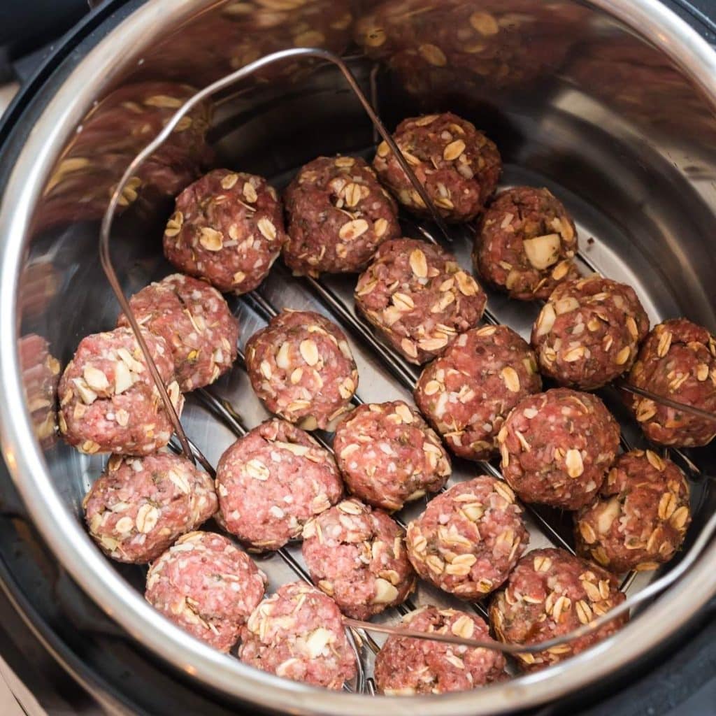 Meatballs inside an instant pot before being cooked.