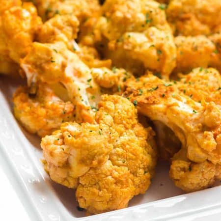 air fried buffalo cauliflower on a white square plate.