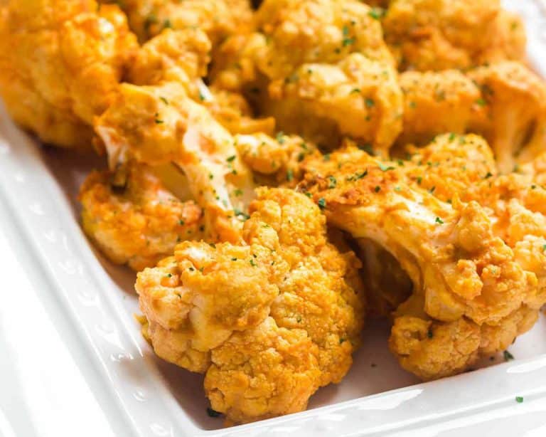 air fried buffalo cauliflower on a white square plate.