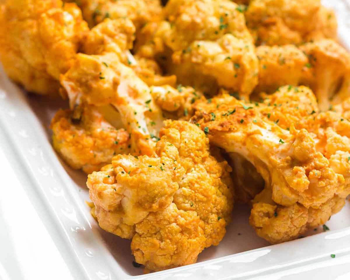 Air fried buffalo cauliflower on a white square plate.
