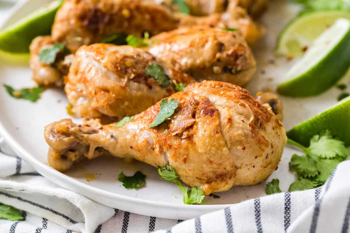 close up of cooked chicken drumstick with chopped cilantro on top.