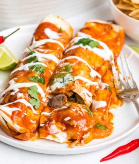 white plate with two Healthy Carne Asada Enchiladas