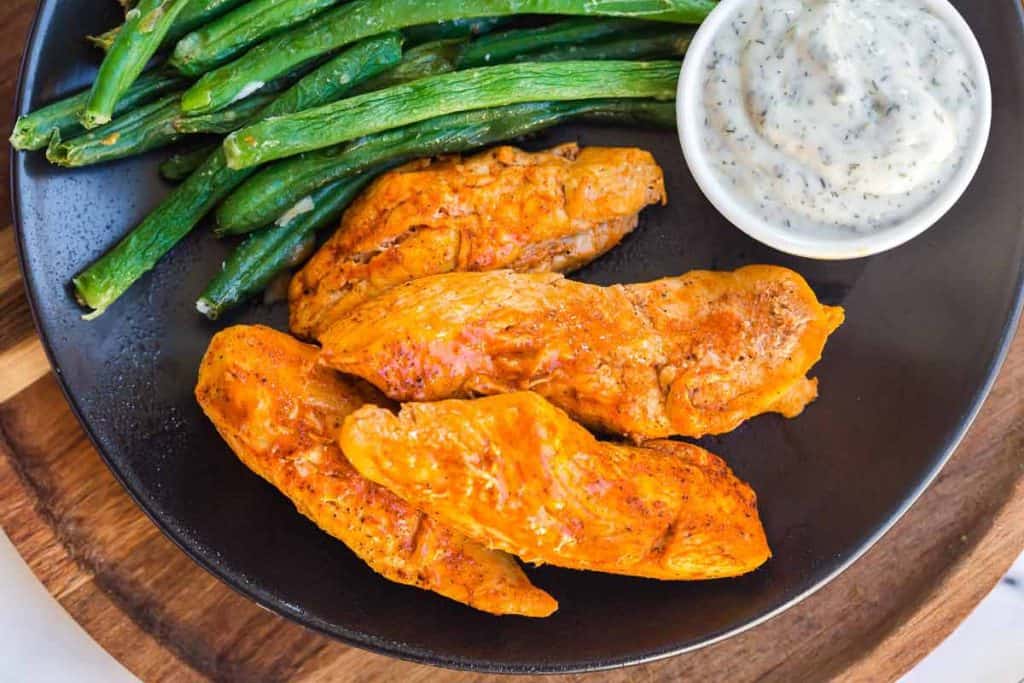 plate with Instant Pot Buffalo Chicken Bites, ranch dip, and asparagus