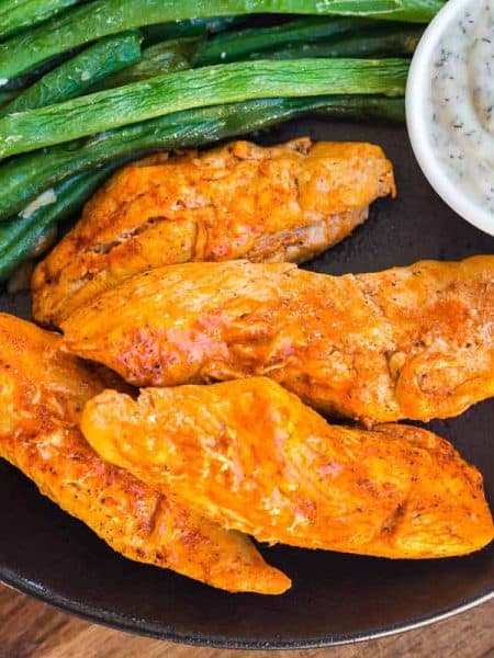 plate with Instant Pot Buffalo Chicken Bites, ranch dip, and asparagus