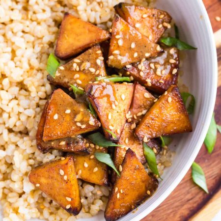close up of air fryer tofu with coconut brown rice in a white bowl