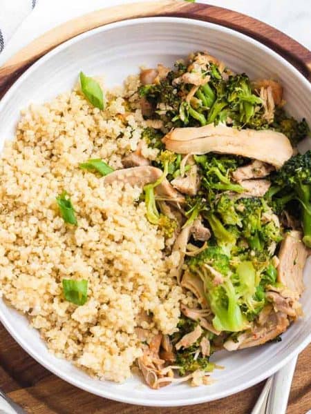 Instant Pot Honey Garlic Chicken in a white bowl on top of a wooden platter