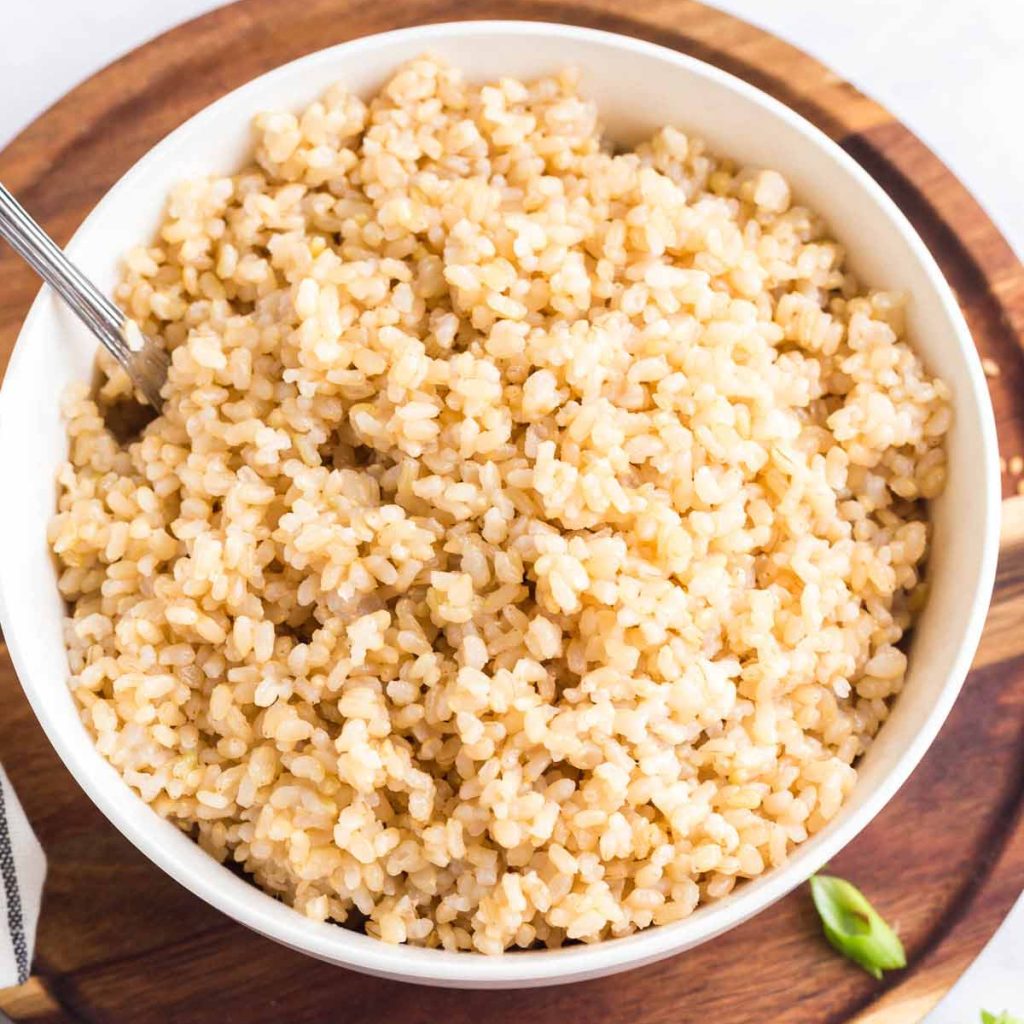 cooked coconut brown rice in a white bowl