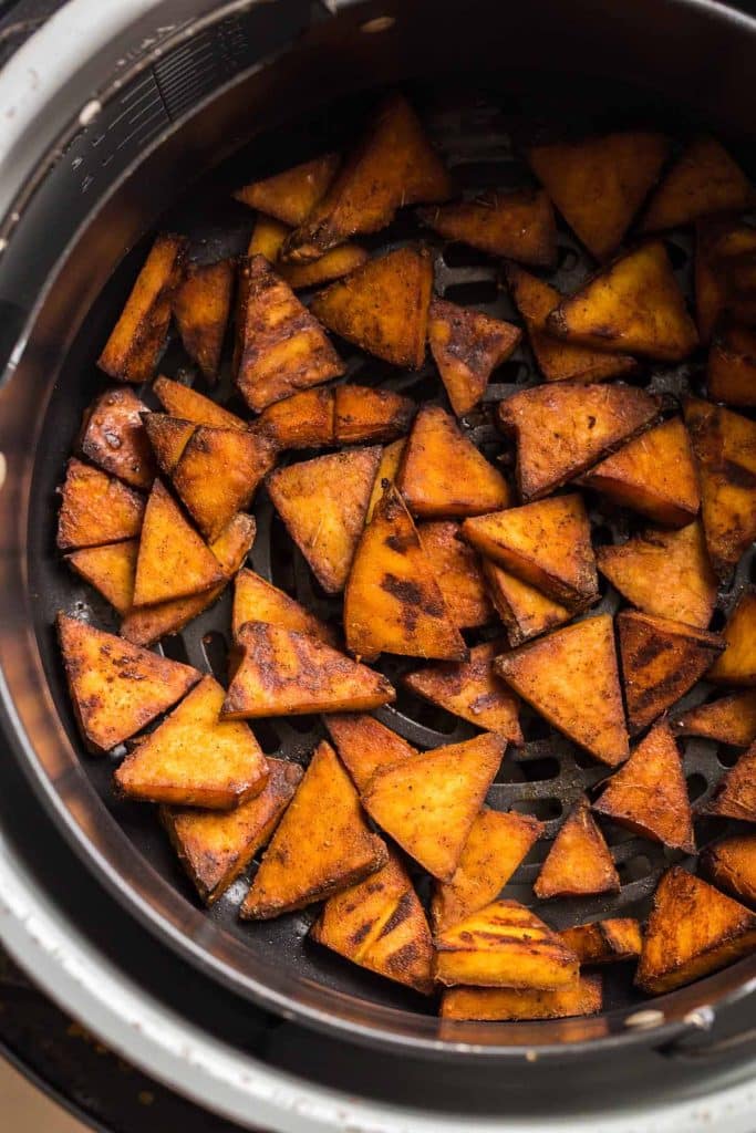 cooked tofu in an air fryer basket