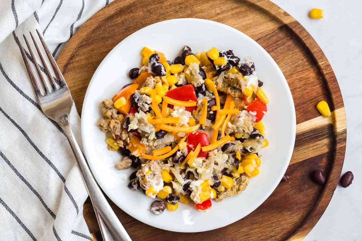 Easy breakfast casserole with potatoes on a white plate.
