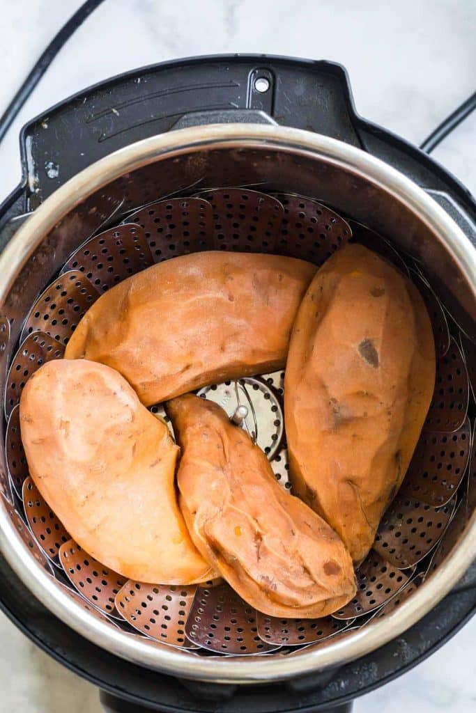 four cooked sweet potatoes inside of an instant pot