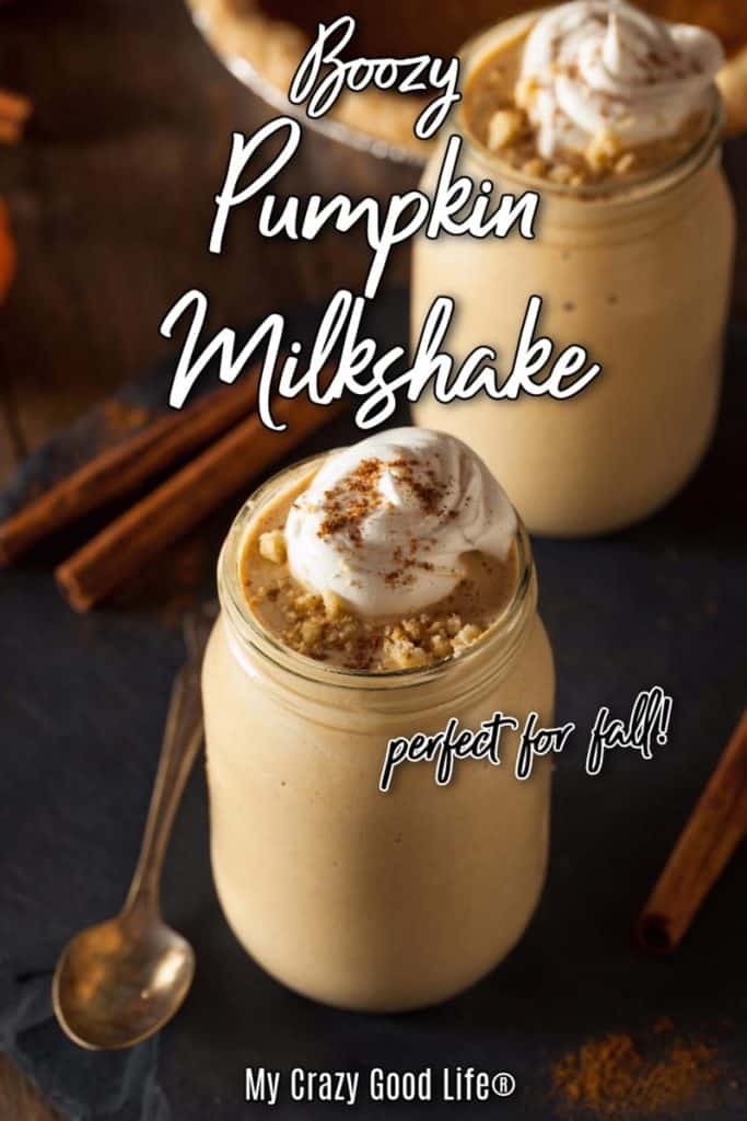 dark background with pumpkin milkshake in a glass mason jar. Shake has whipped cream and cinnamon decoration on top.