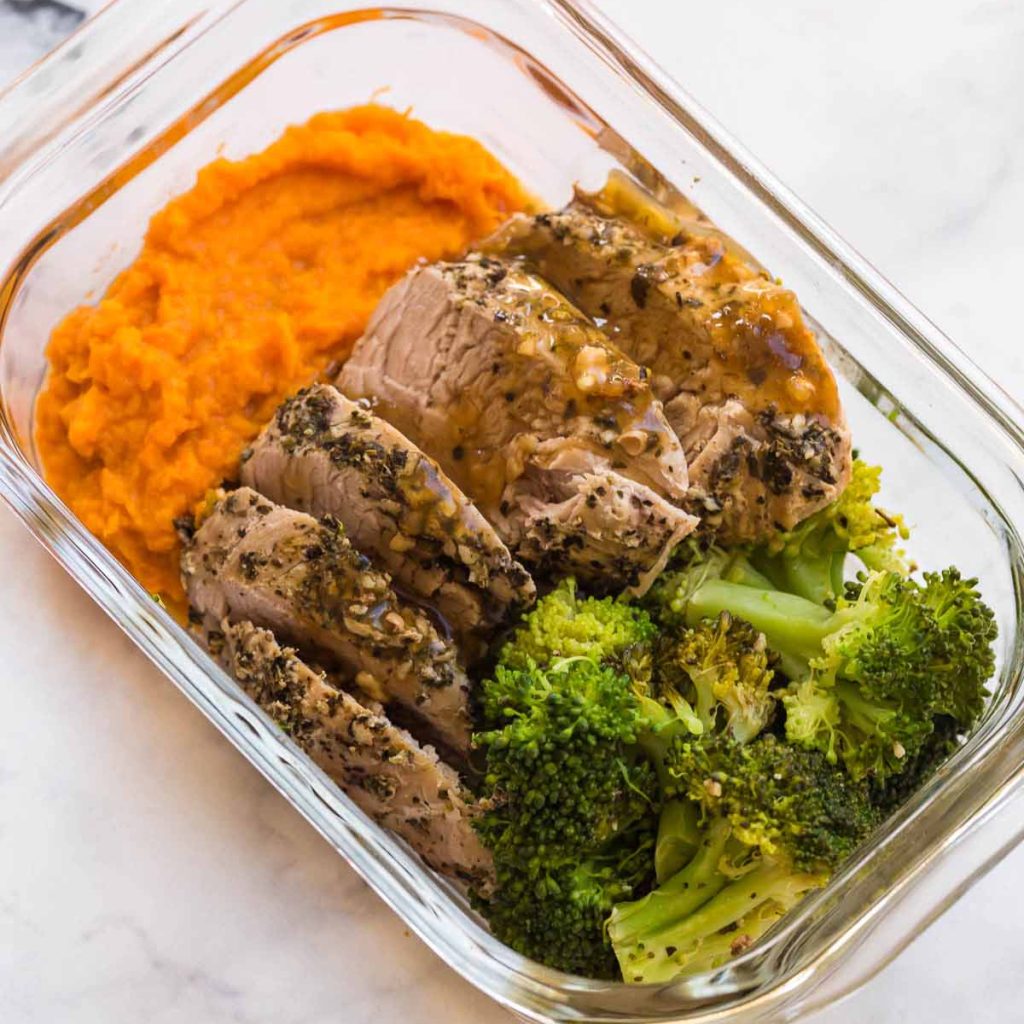 cooked pork with sweet potato mash and broccoli in s glass meal prep container