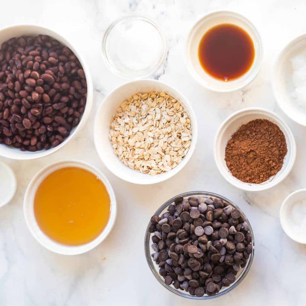 small bowls filled with measured ingredients to make black bean brownies