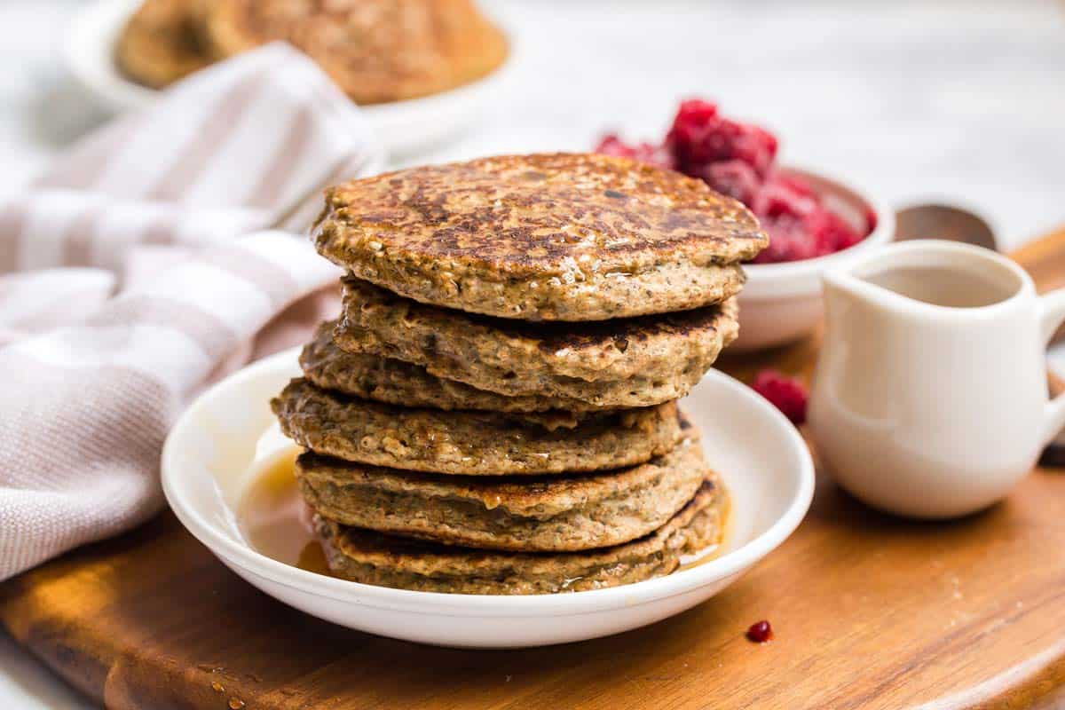 A white plate with a stack of Vegan Whole Wheat Pancakes.