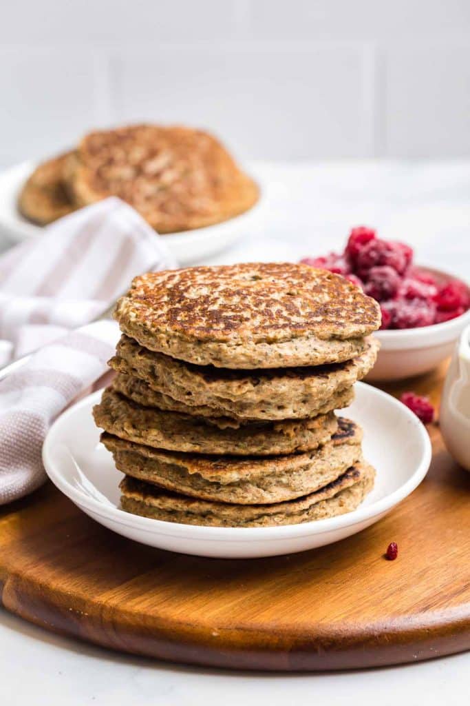stack of cooked whole wheat pancakes on a white plate