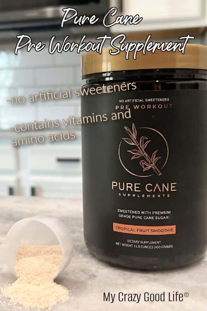 close up of pure cane pre workout powder on a marble counter. One scoop of powder is lying sideways on the counter with powder pouring out. 