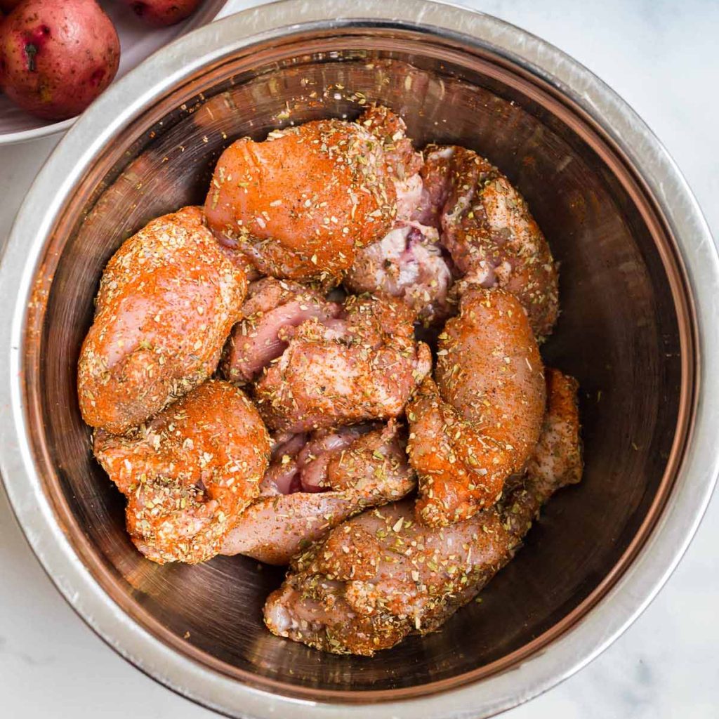 seasoned chicken thighs in an instant pot ready to be seared