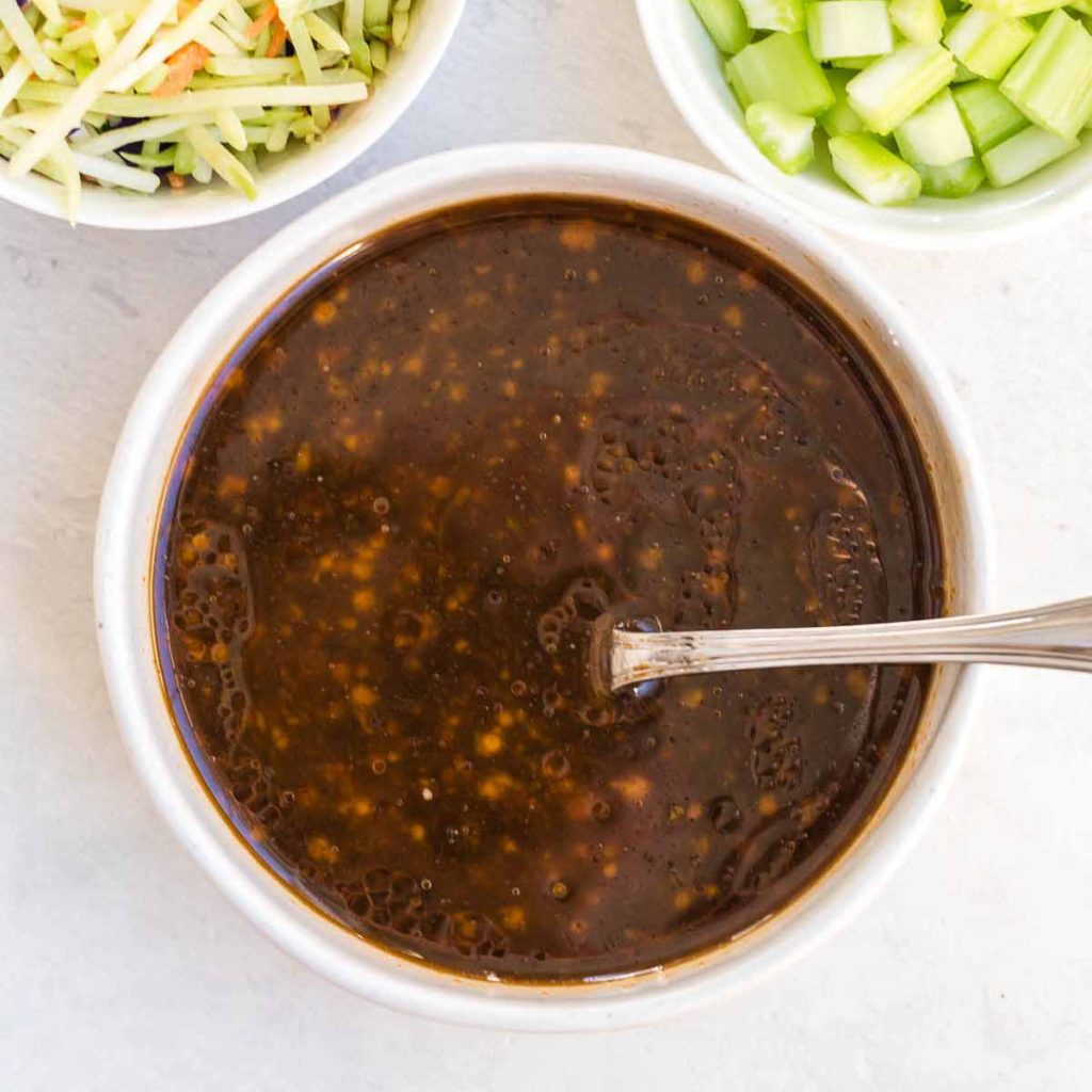 sauce for vegetable lo mein in a small white bowl
