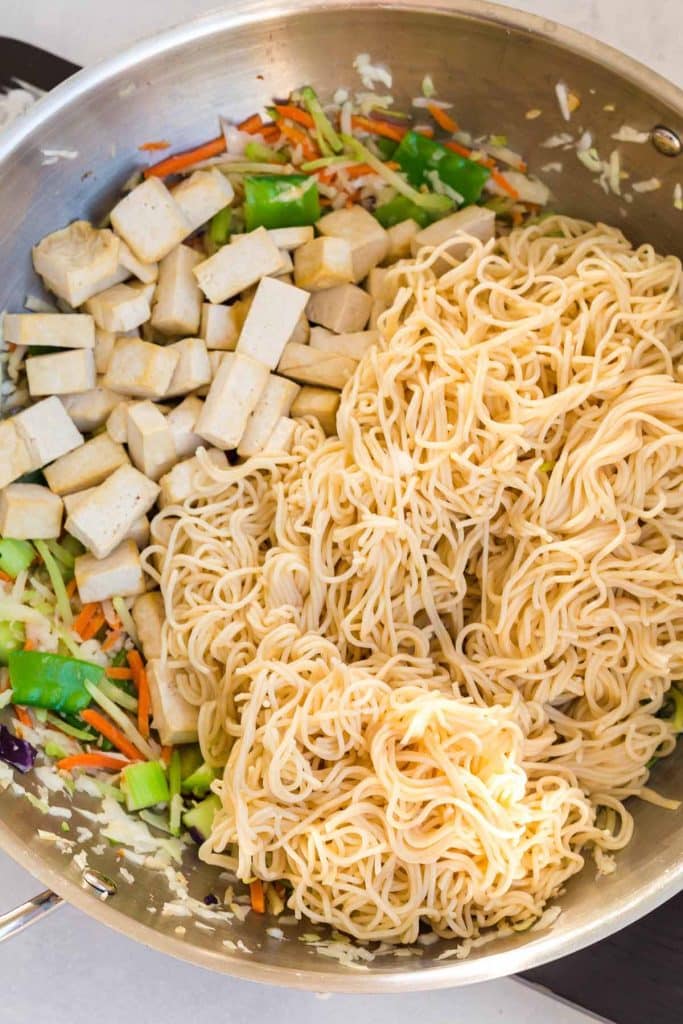 stainless pan with noodles and tofu on top