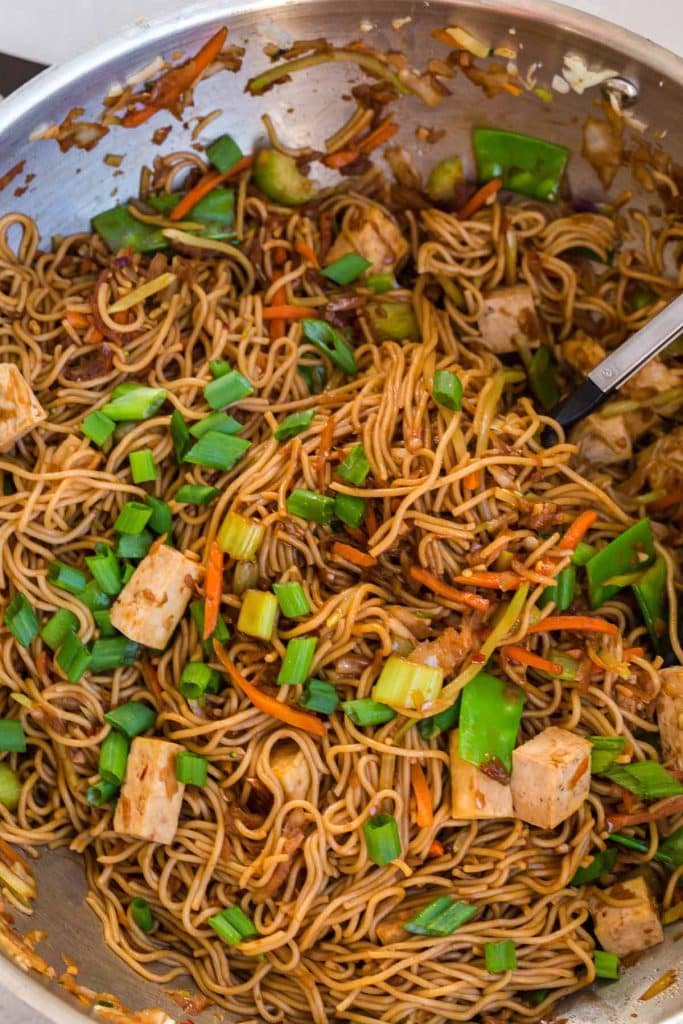 cooked vegetable lo mein in a stainless pan