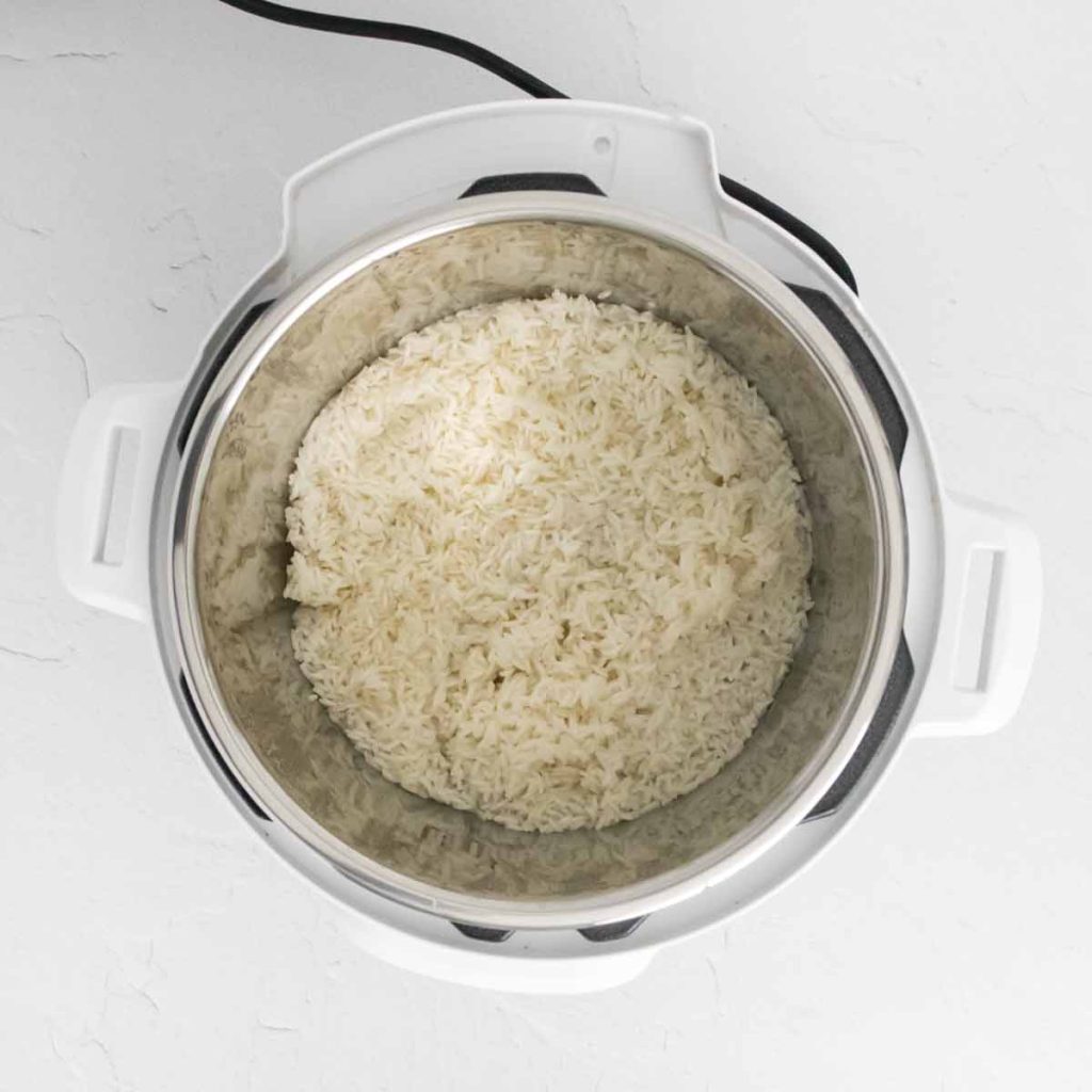 top down image of cooked white rice in a white Instant Pot