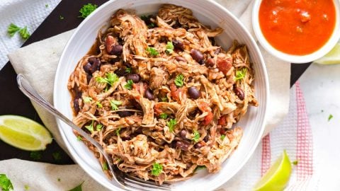 white bowl with shredded chicken burrito bowl inside