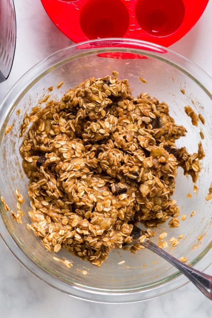 glass bowl with ingredients mixed together to make banana oatmeal bites