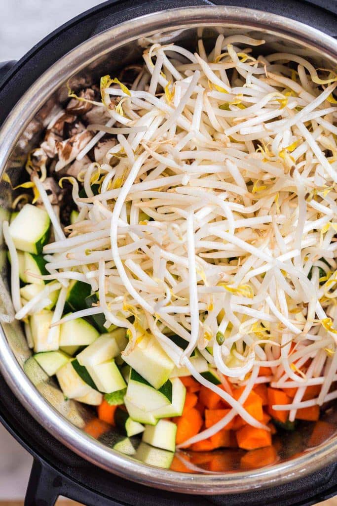 top down view of Instant Pot filled with raw vegetables
