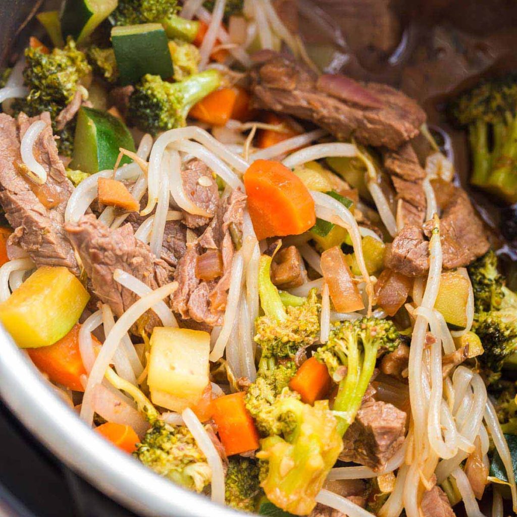 top down view of Instant Pot with cooked stir fry veggies and steak
