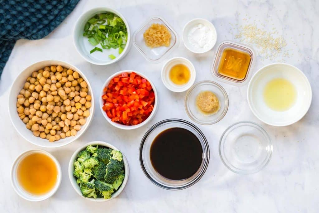 small bowls filled with ingredients to make sticky sesame chickpeas and veggies