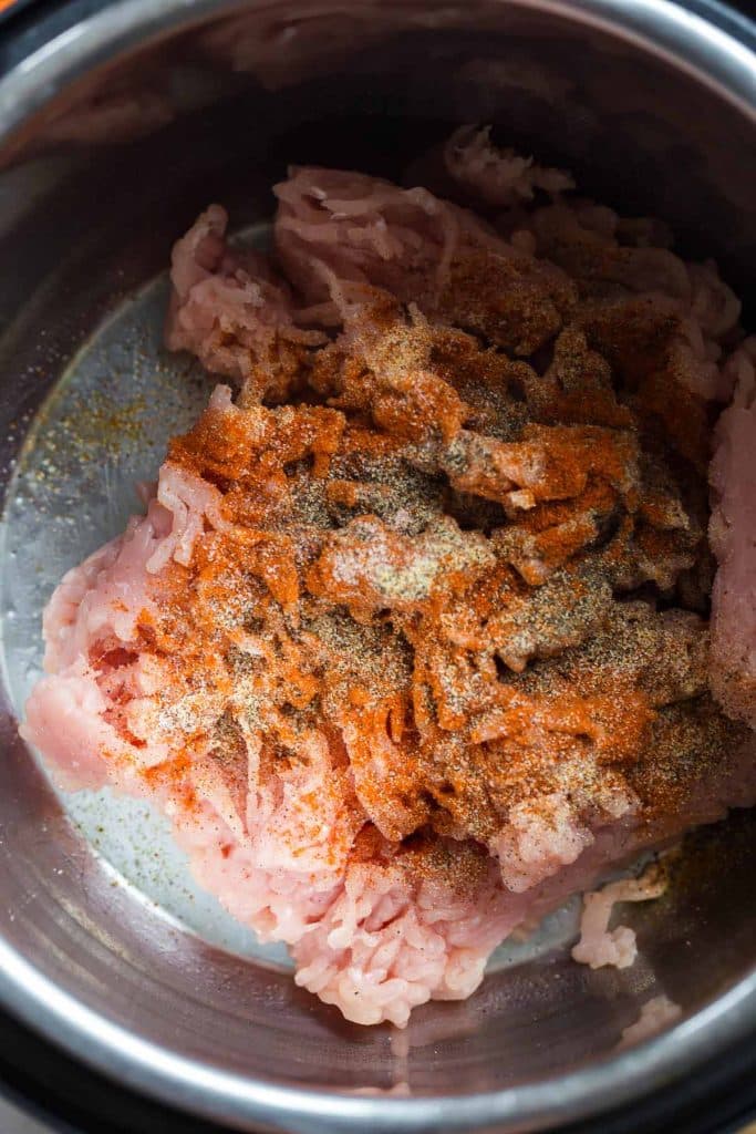 ground meat and spices cooking in the instant pot
