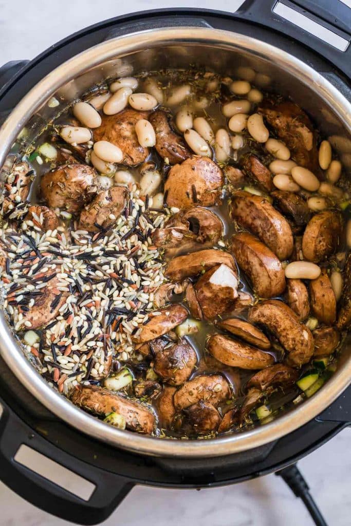 rice, mushrooms, and beans shown in an instant pot