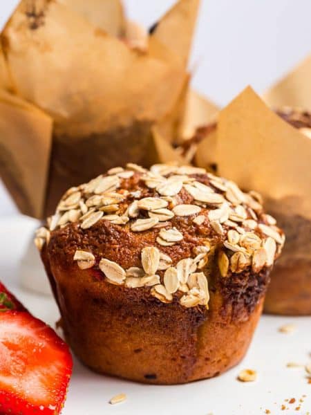 Strawberry Muffins on a white plate with cut strawberry