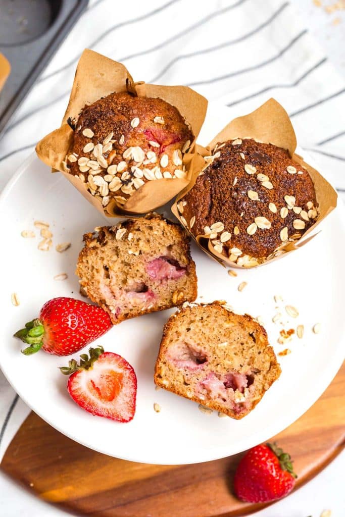 elevated cake plate with muffins on it, one is cut in half