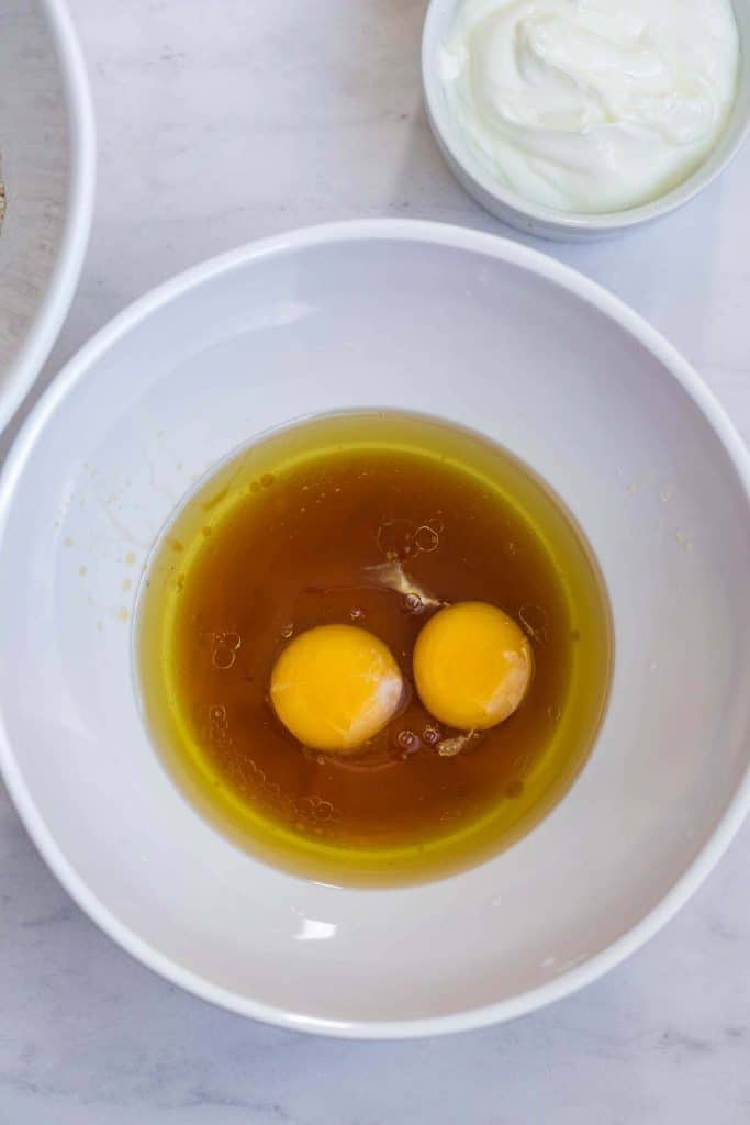 white bowl on white countertop with beginning of wet ingredients
