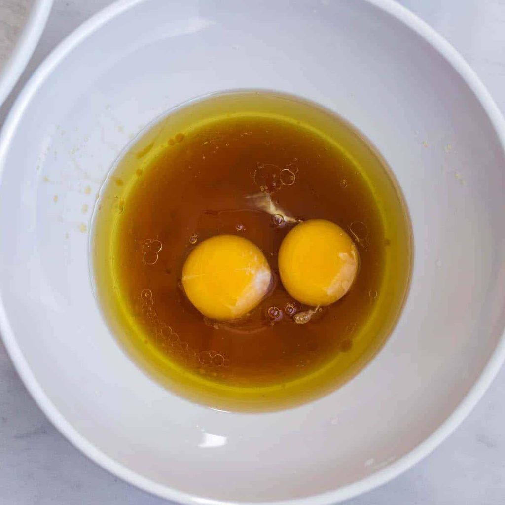 white bowl on white countertop with beginning of wet ingredients