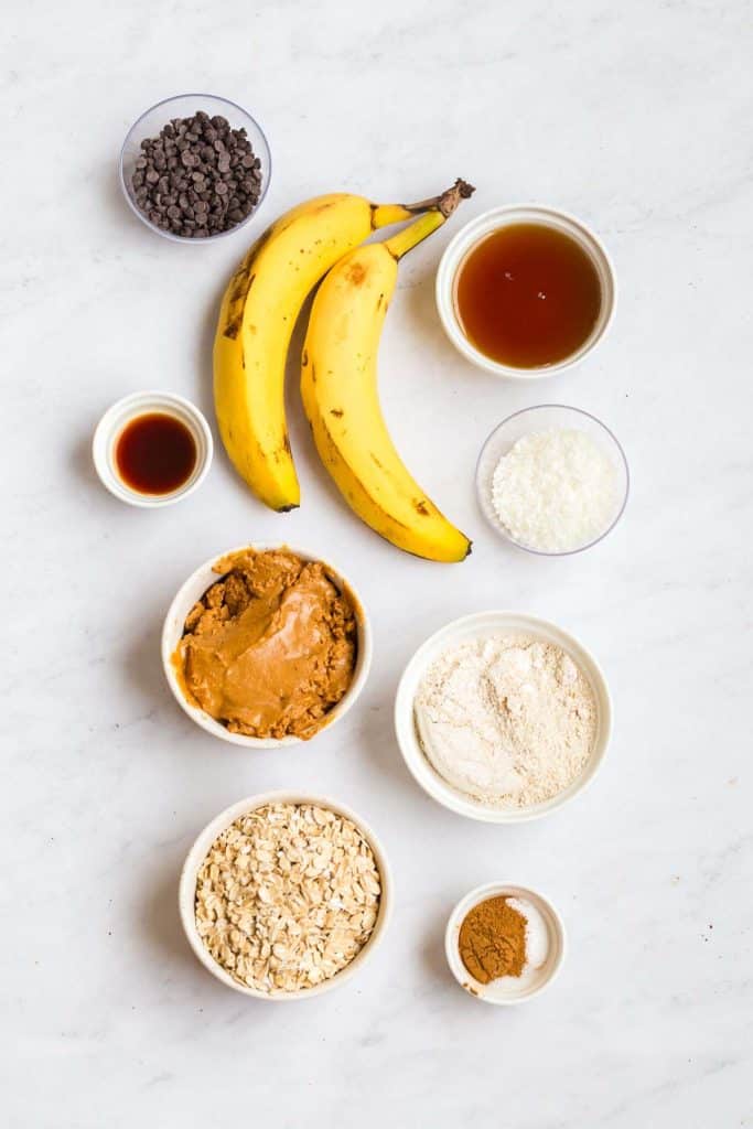 top down image of ingredients for this recipe: bananas, several white bowls with ingredients. 