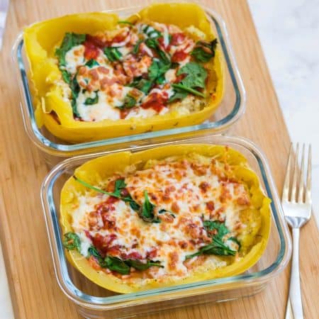 two glass meal prep containers with spaghetti squash lasagna inside.