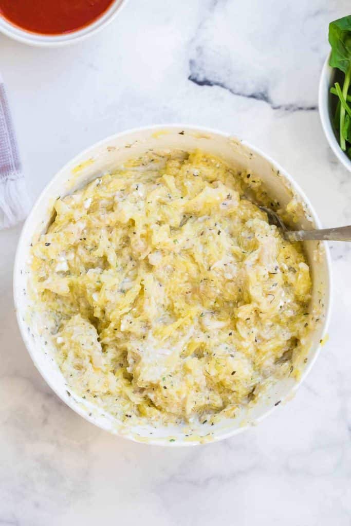 bowl with a mixture of cauliflower, cottage cheese, greek yogurt and spices for lasagna filling