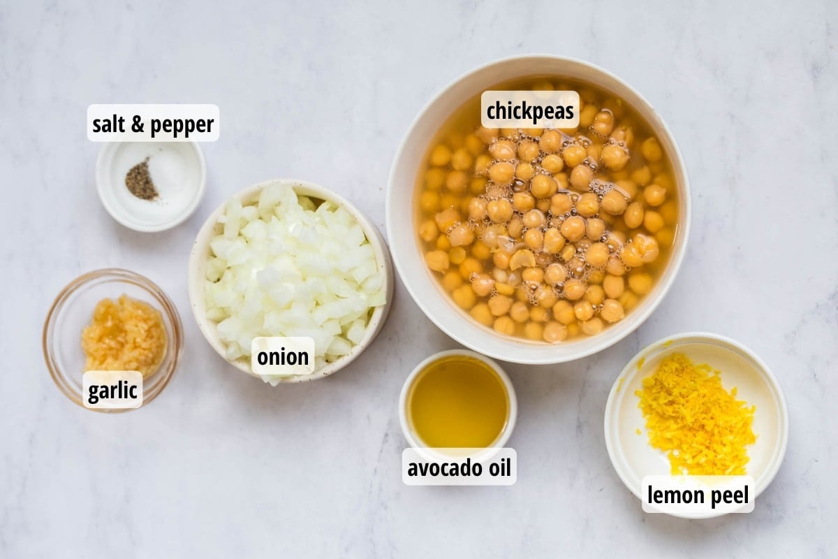Labeled ingredients in white and glass bowls on top of a white counter top.