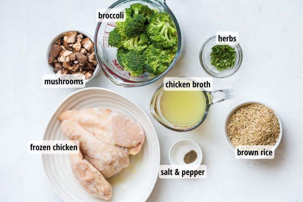 Ingredients needed to make Chicken and Rice with Vegetables on a white counter, with labels for each ingredient.